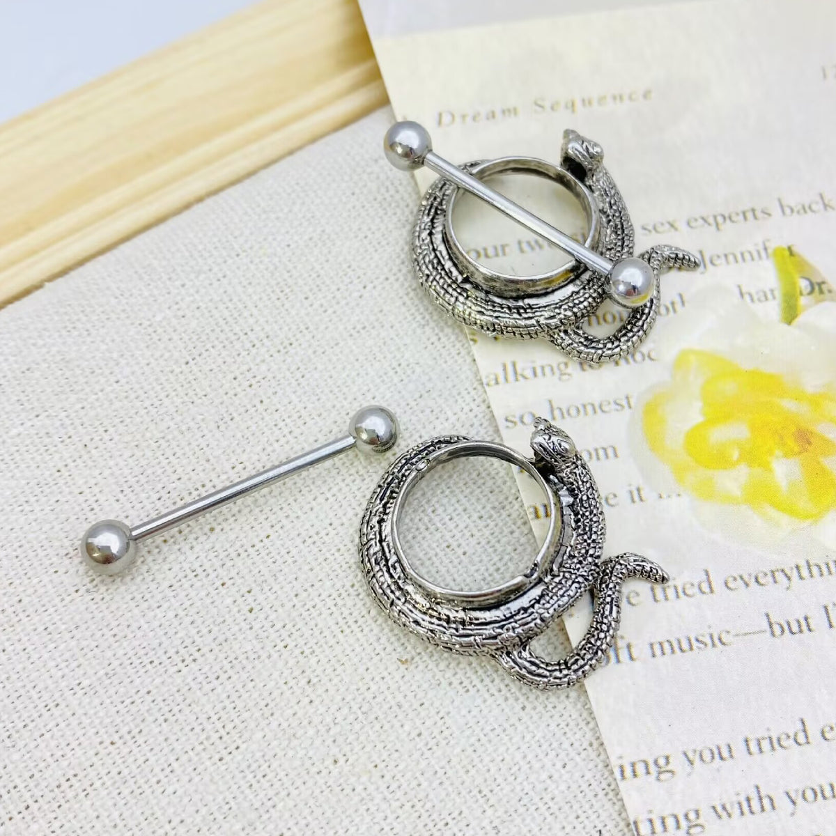 Two snake nipple shields placed on a vintage background, showcasing punk style.
