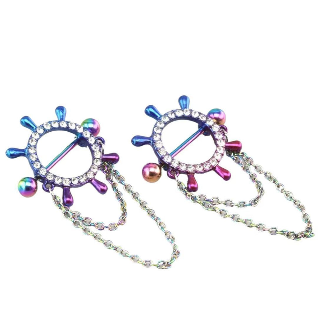 Side angled view of a pair of colorful rainbow anodized ship's wheel nipple rings with straight barbells showing the detailed crystal craftsmanship.