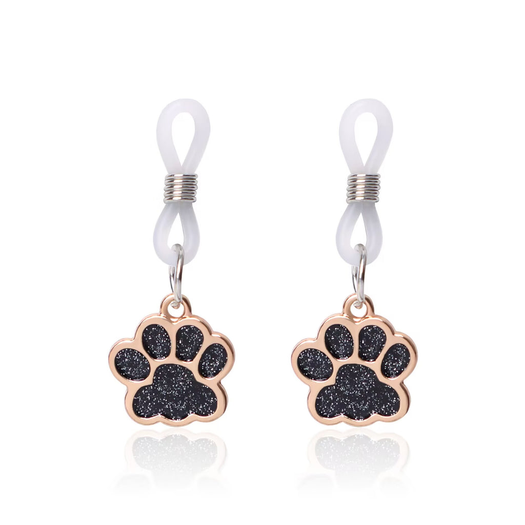 A pair of black shimmering paw print non-pierced nipple accessories with clear loops.