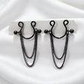 A pair of sleek black minimalist goth faux nipple rings featuring layered dangle chains on a white satin background.