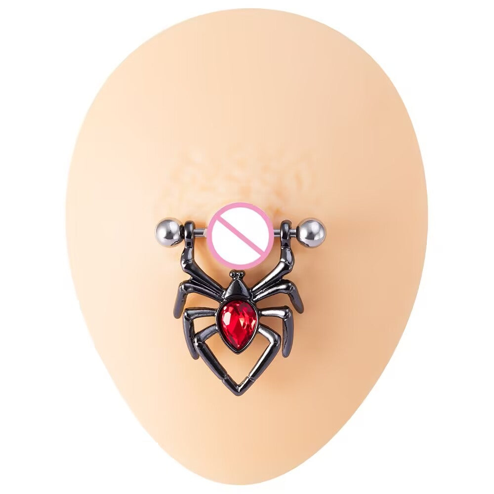 Black spider nipple shield ring with a red gem displayed on a realistic skin silicone mold.