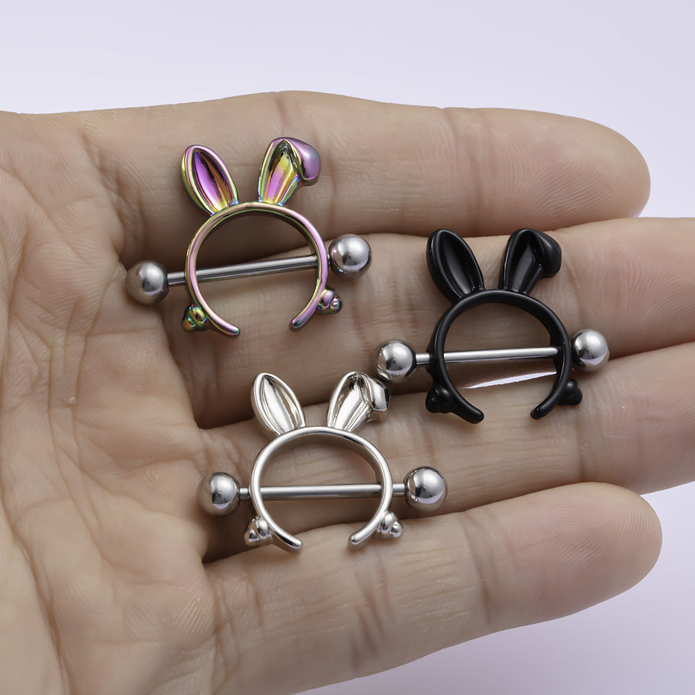 Three different colors of bunny ear nipple shields held in a palm.