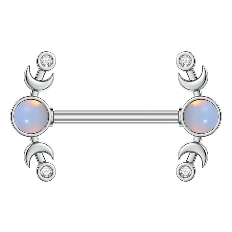 A front view of a silver-colored 14G nipple piercing barbell with dual crescent moons, clear mini crystals, and a glowing central opal stone.