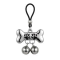An adjustable dog bone shape nipple loop clamp featuring black paw prints and two dangling bells for pet play roleplay