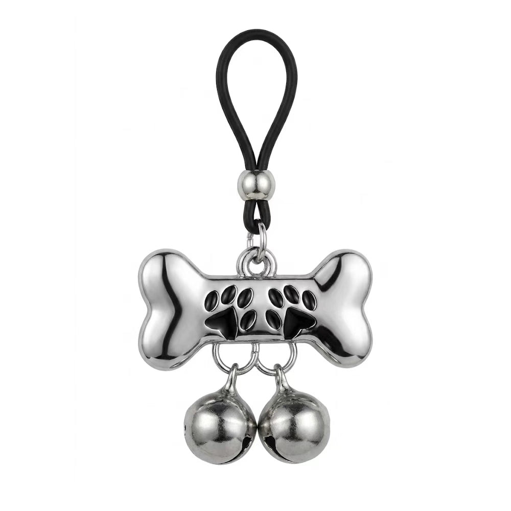 An adjustable dog bone shape nipple loop clamp featuring black paw prints and two dangling bells for pet play roleplay