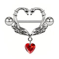 Front view of a swan heart nipple shield highlighting the intricate wing texture and dangling red gem.