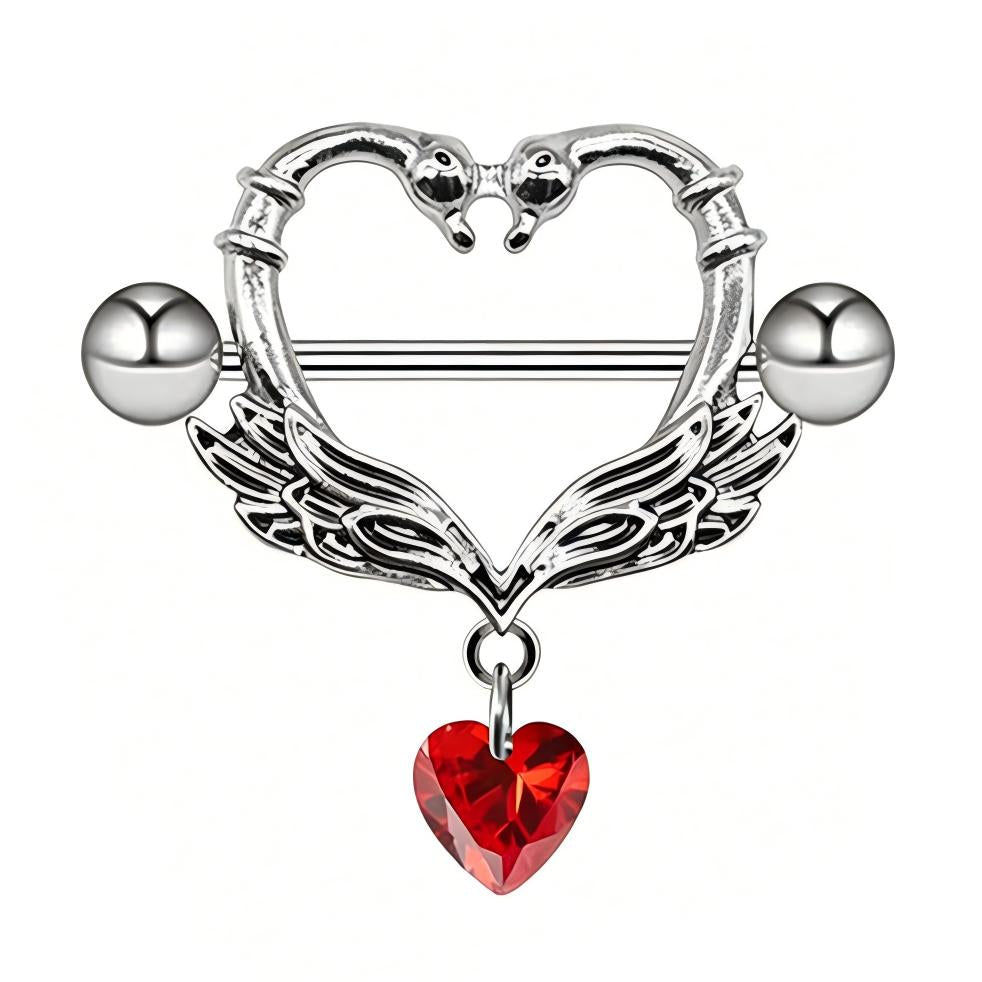 Front view of a swan heart nipple shield highlighting the intricate wing texture and dangling red gem.