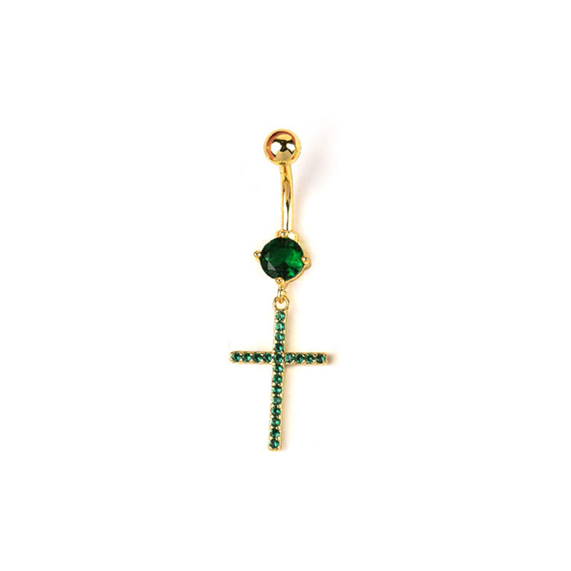 A curved dangle belly button ring featuring a vibrant round green crystal and an emerald green rhinestone-encrusted cross pendant on a polished gold-tone base.
