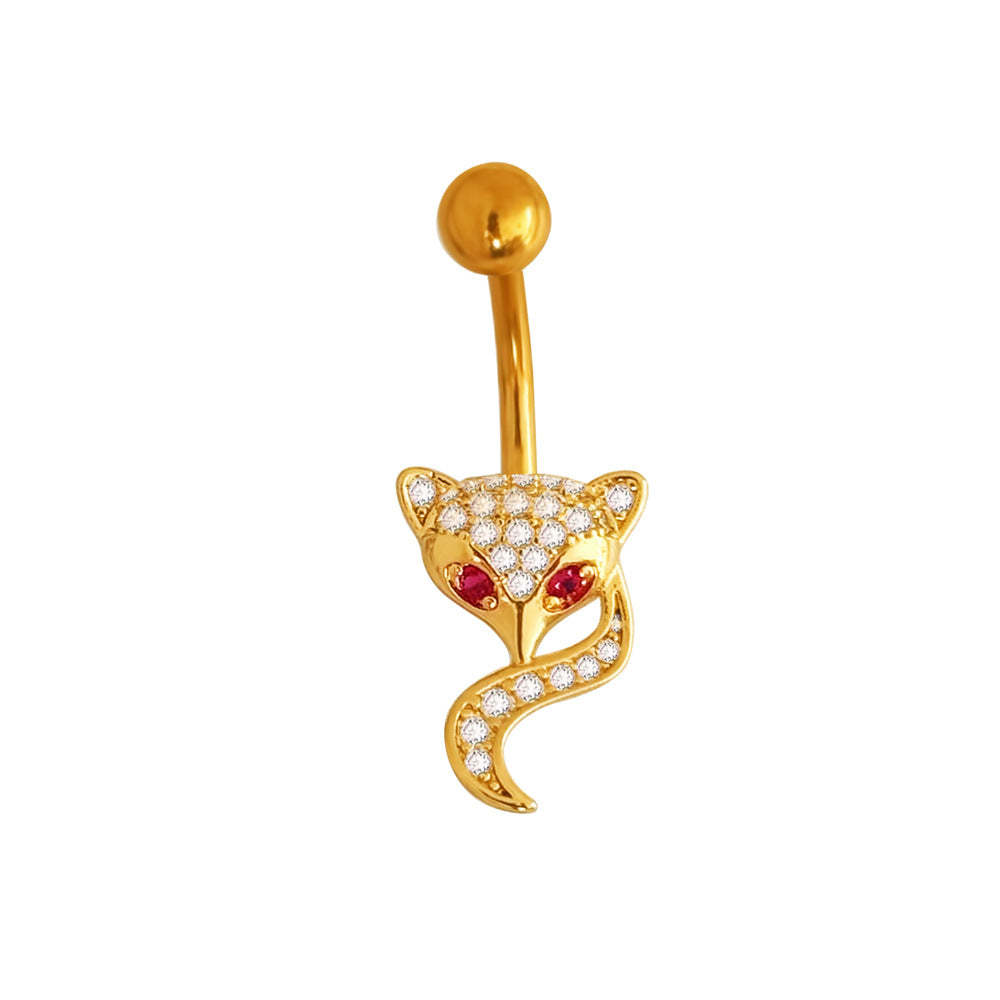 Gold animal-themed navel piercing featuring a crystal-encrusted fox design with red eyes and a shimmering curved tail