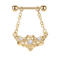 Front view of a gold filigree nipple shield with three crystals and hanging chains on a white background