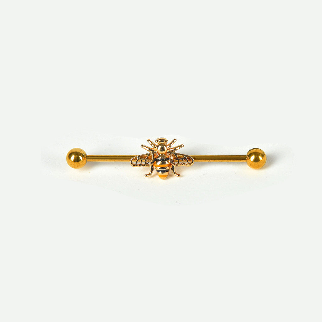 A single gold industrial piercing barbell featuring a highly detailed honeybee with black and yellow stripes