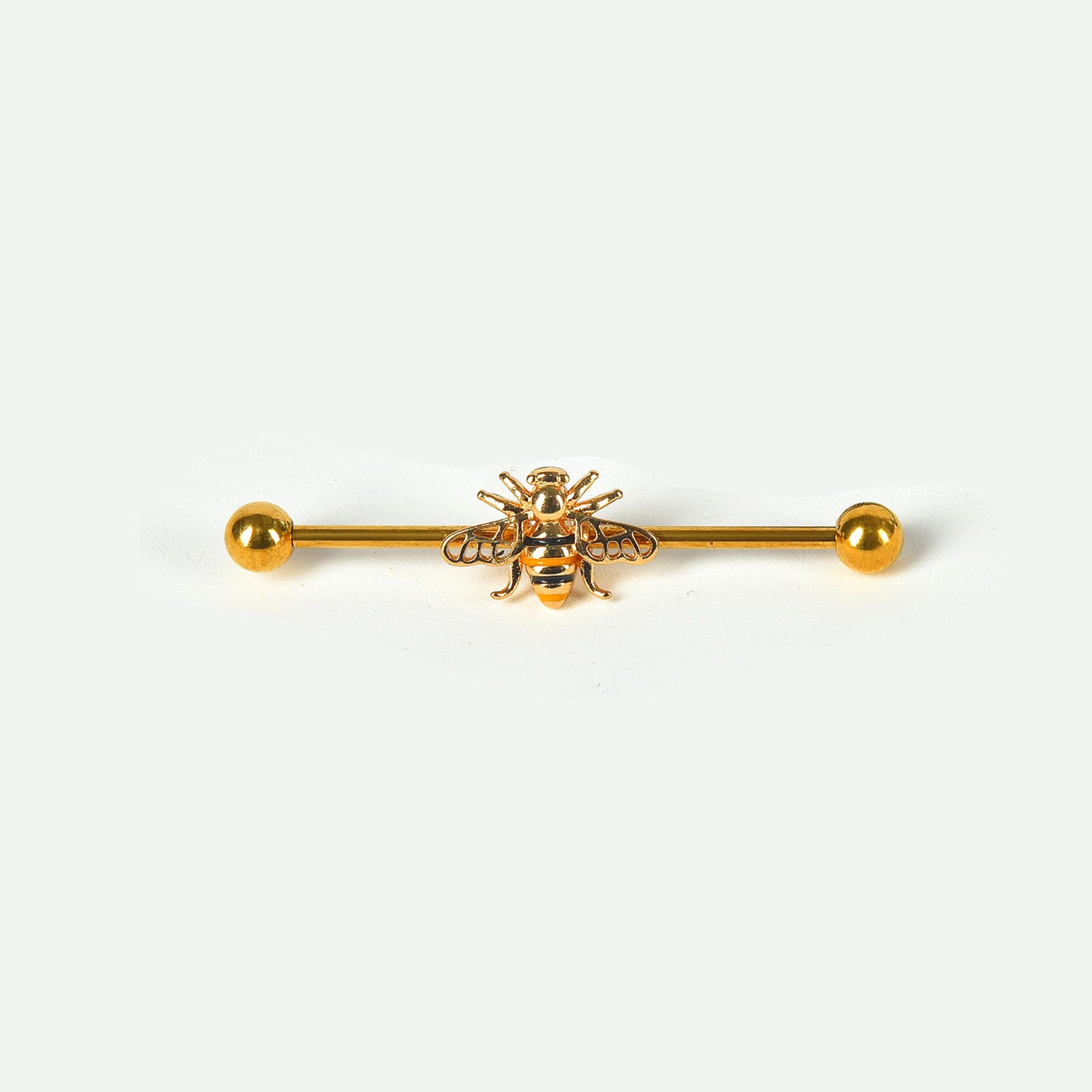 A single gold industrial piercing barbell featuring a highly detailed honeybee with black and yellow stripes