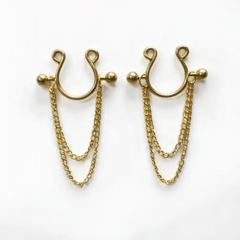 A pair of radiant gold-colored faux nipple rings with hanging chain design for festival and lingerie outfits.