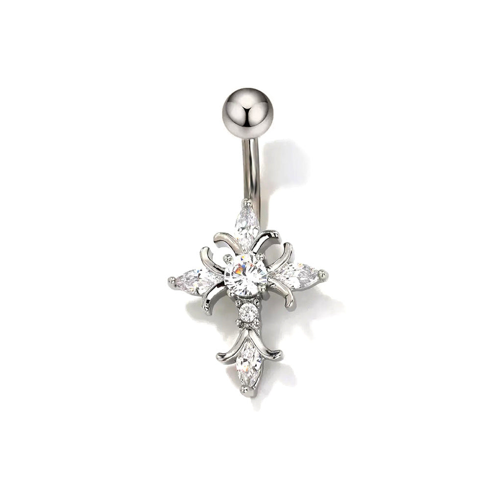 A close-up shot of a silver-toned gothic cross navel ring featuring a central round clear crystal and marquise-cut white gems