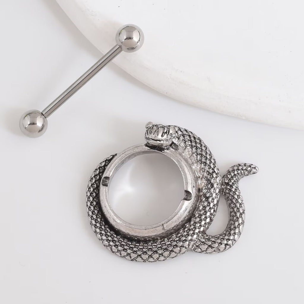 Close-up of the detachable bar and snake shield base for body piercing.
