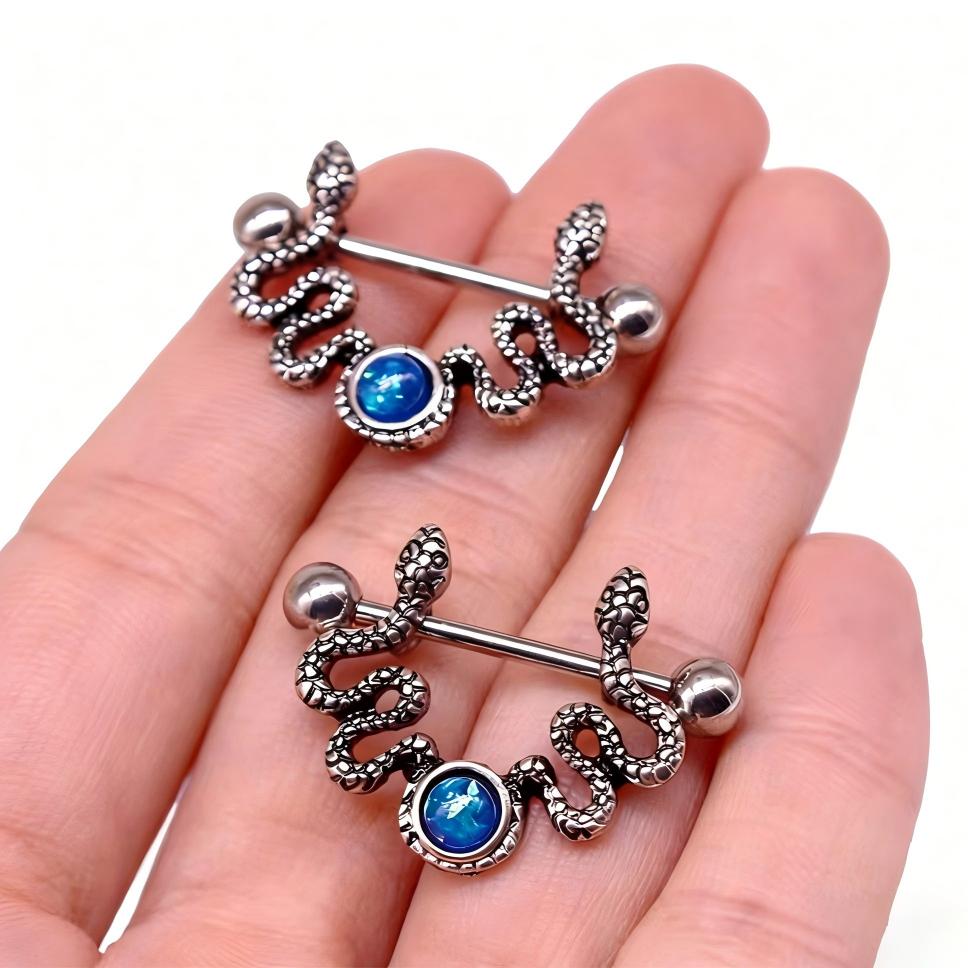 Handheld view showing the detailed texture of the snake scales and blue opal stone.