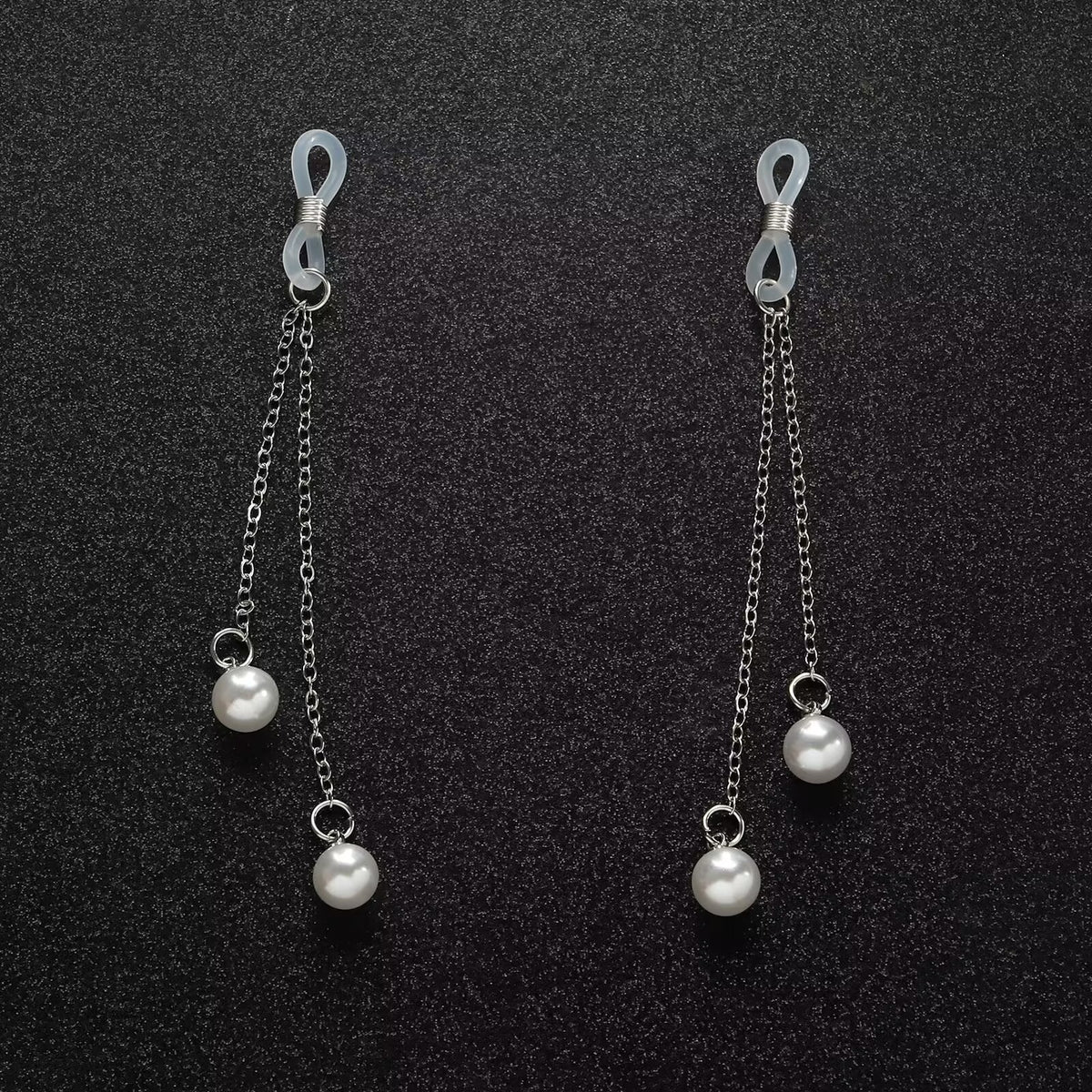 Elegant pearl dangle fake piercing nipple jewelry displayed beautifully on a textured black background, showcasing the minimalist indie aesthetic.