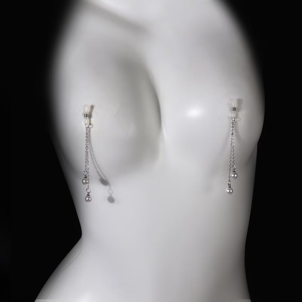 A white female mannequin wearing the adjustable faux pearl non-piercing nipple chain jewelry to showcase the dangle drop and realistic wear effect.