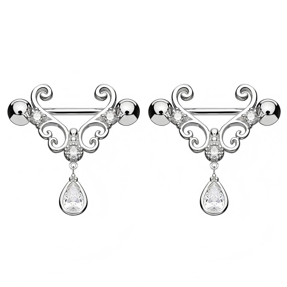 A pair of matching silver-tone nipple shields with intricate scrollwork and teardrop pendants