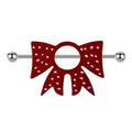 Front view of a red bow nipple shield with pink polka dots on a white background