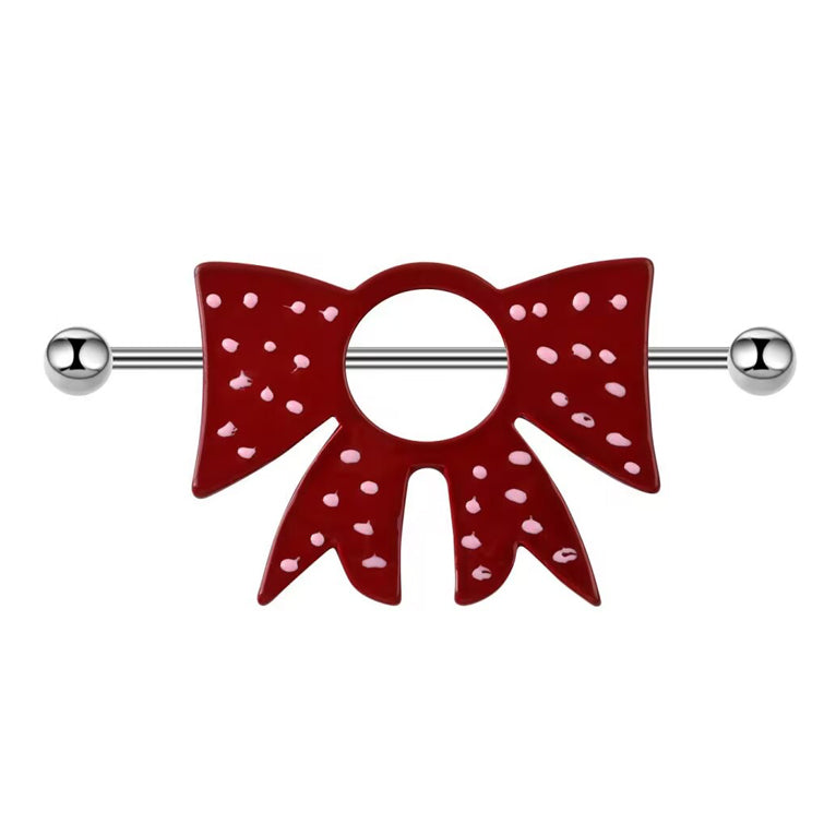 Front view of a red bow nipple shield with pink polka dots on a white background