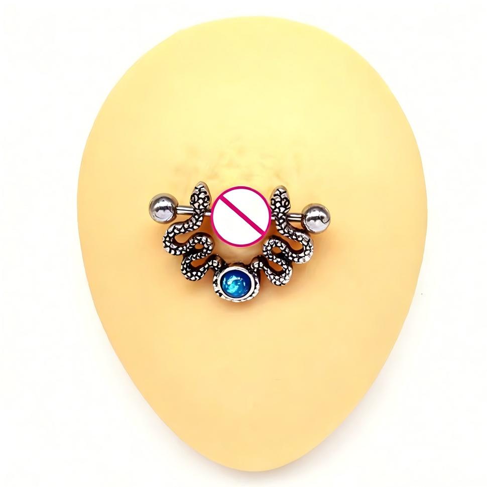 Close-up of a twin serpent nipple shield worn on a silicone training model.