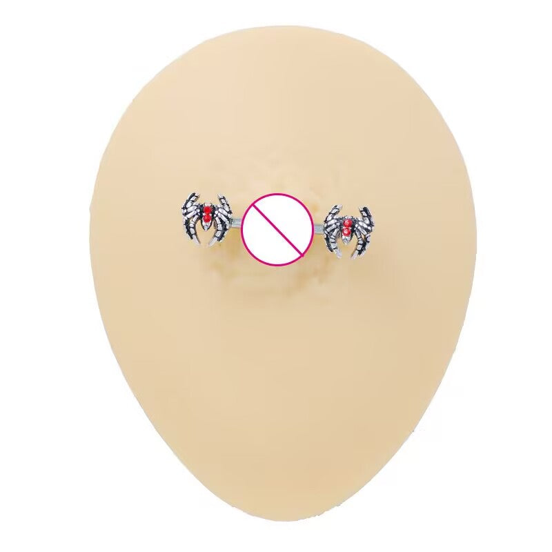 Realistic display of spider nipple barbells on a skin-toned silicone piercing model.