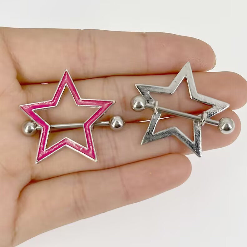 Hand holding star nipple shields to show product scale and enamel finish