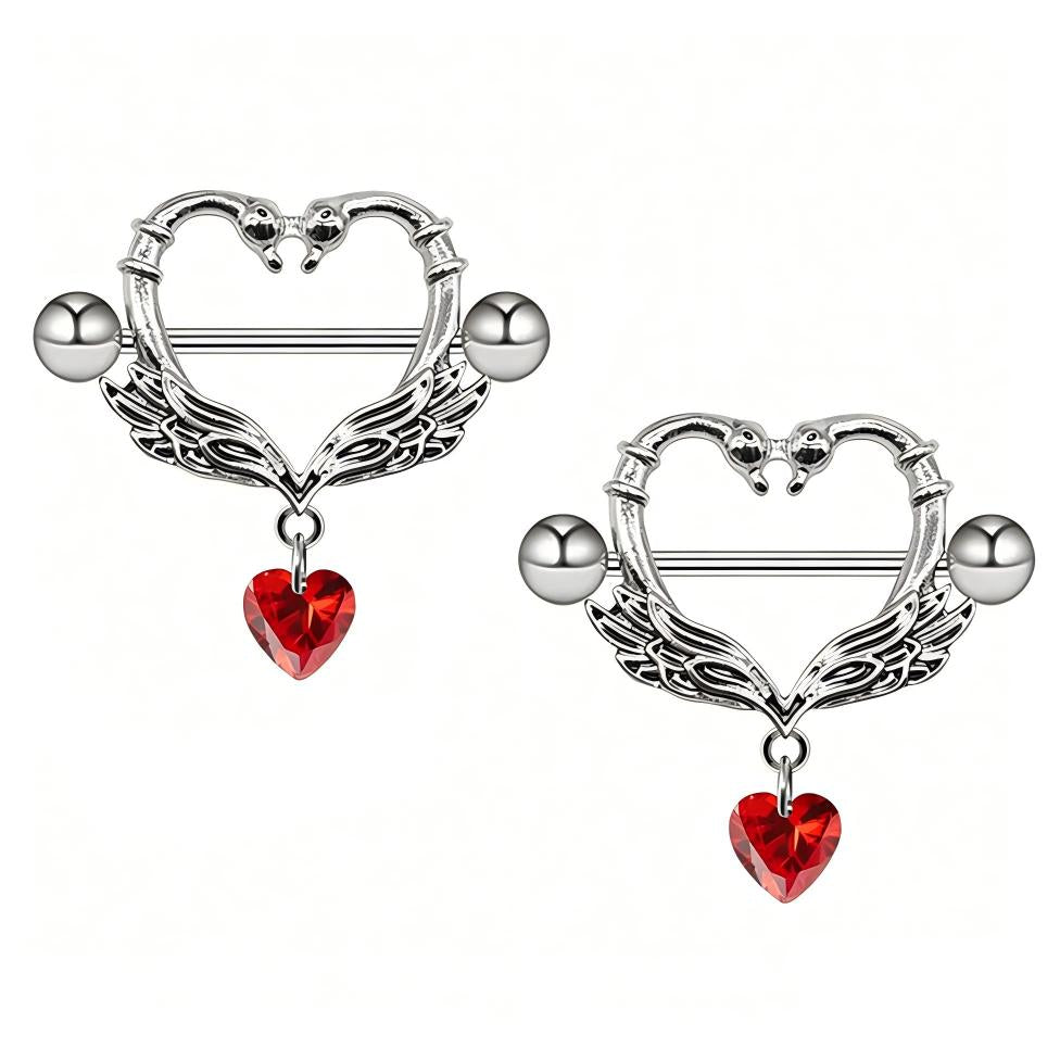 Two swan-themed nipple shields with red crystal hearts isolated on a clean white background.