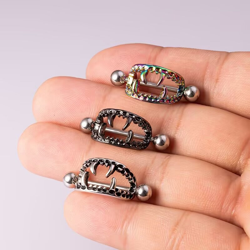 Collection of vampire nipple shields in silver, black, and rainbow colors.