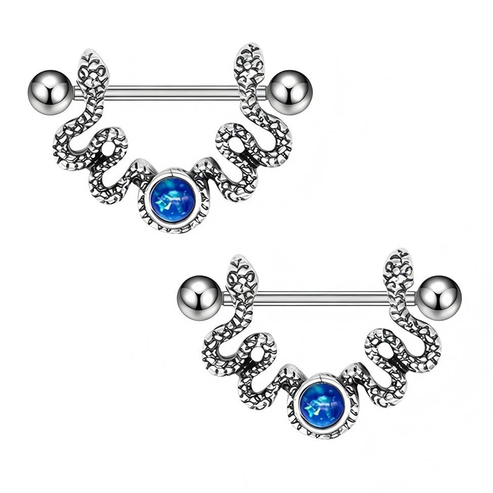 A pair of vintage silver snake nipple shields with blue opal centers on white background.